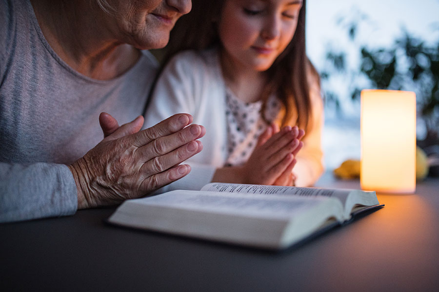 A grandmother and her granddaughter read the Bible together. (iStock)